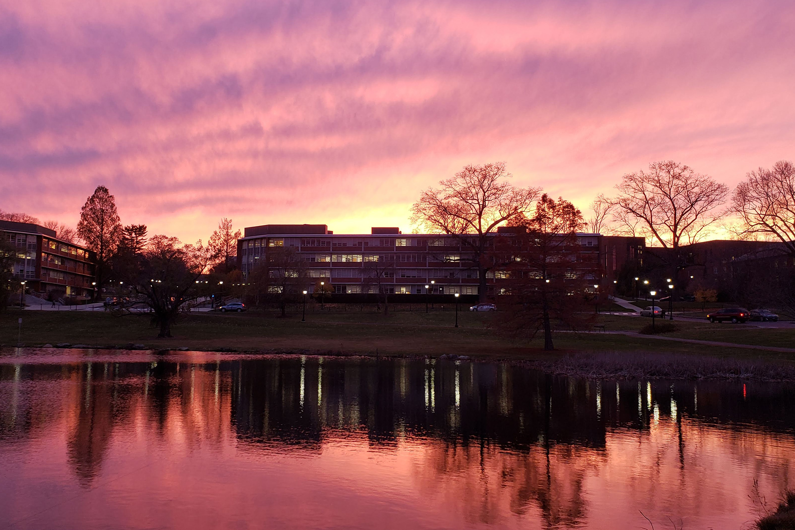 Monteith Hall, exterior at sunset, reflecting in Mirror Lake.